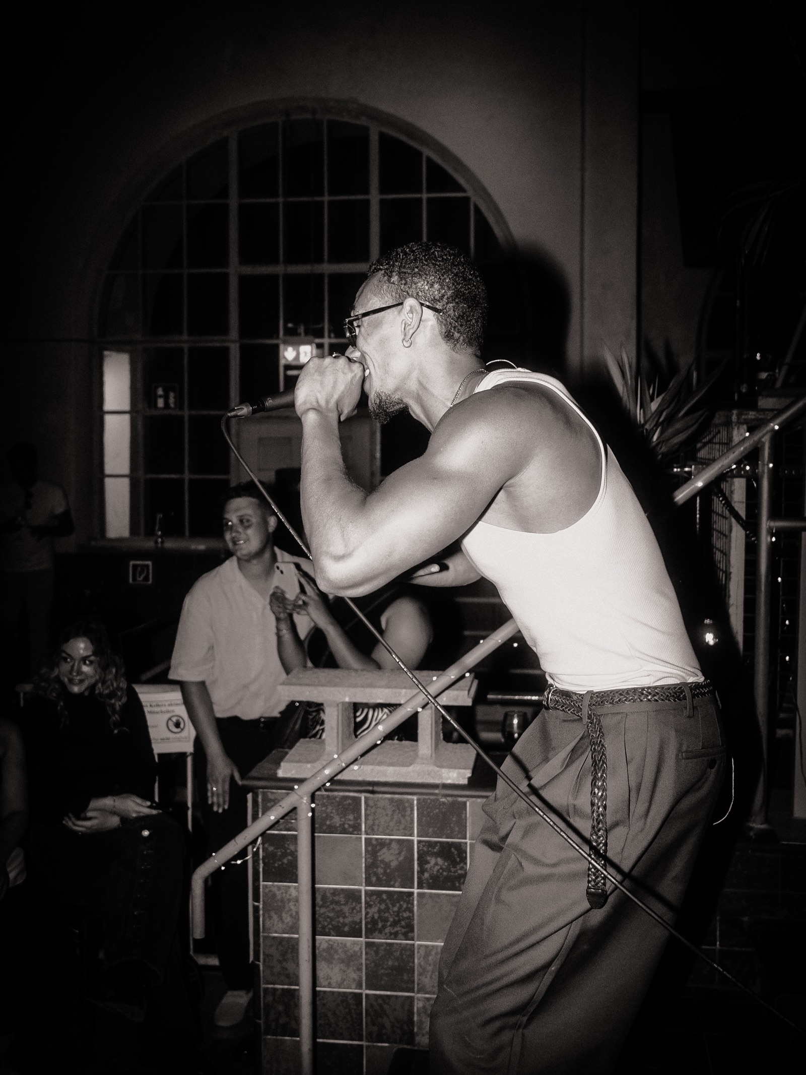 SELAH performing live, black and white side profile at the microphone